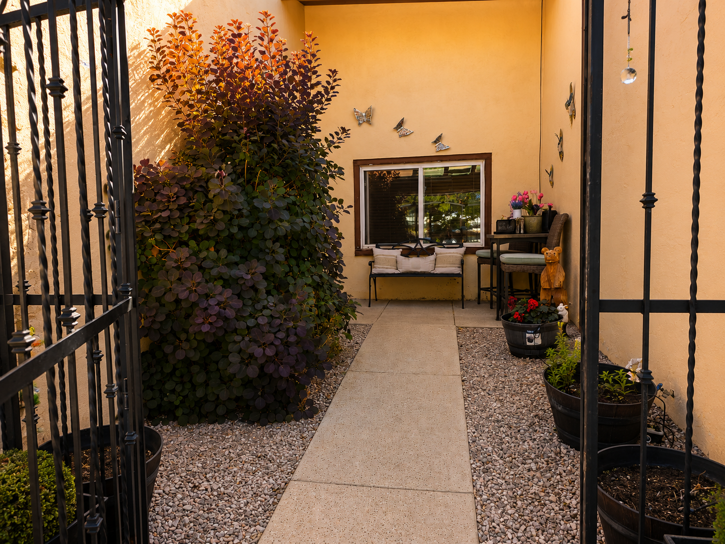 Private courtyard with bench and potted plants